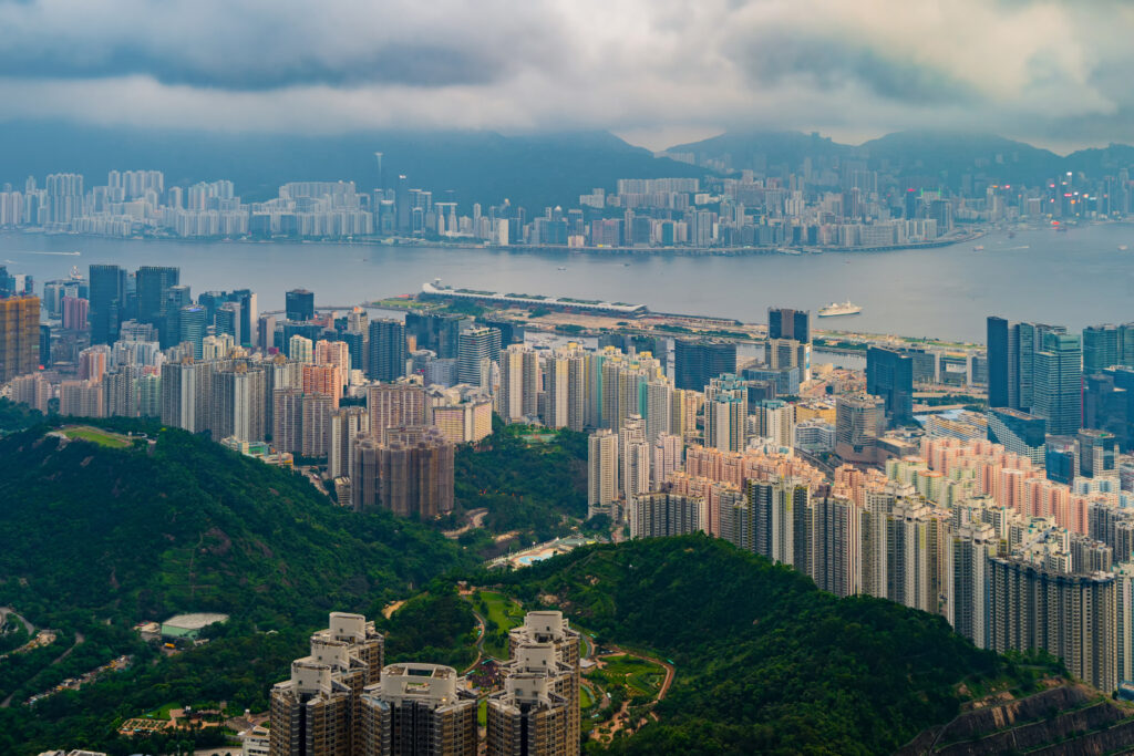 Aerial top view of Hong Kong Downtown, republic of china. Financial district and business centers in smart urban city in Asia. Skyscrapers and high-rise modern buildings at sunset.